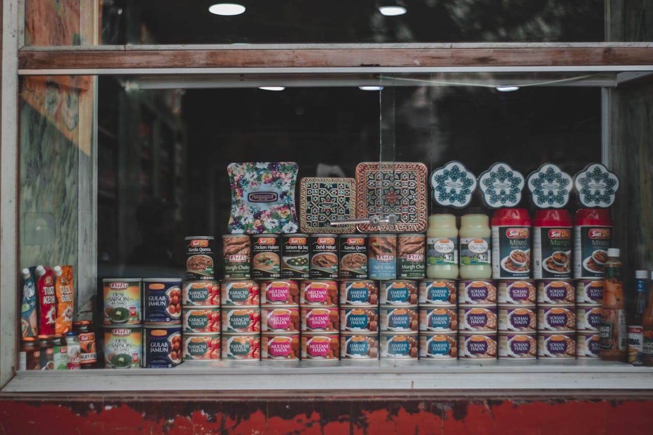about-01 A vibrant selection of canned goods and condiments beautifully arranged in a store window.