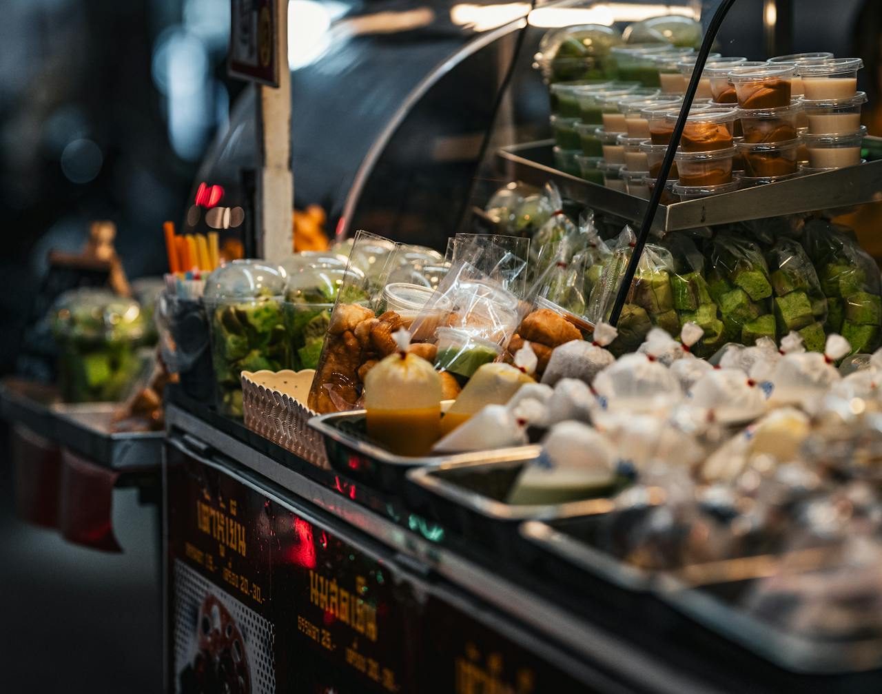 Crafting Captivating Headlines: Your awesome post title goes here Vibrant Thai street food stall showcasing an array of traditional snacks and desserts.